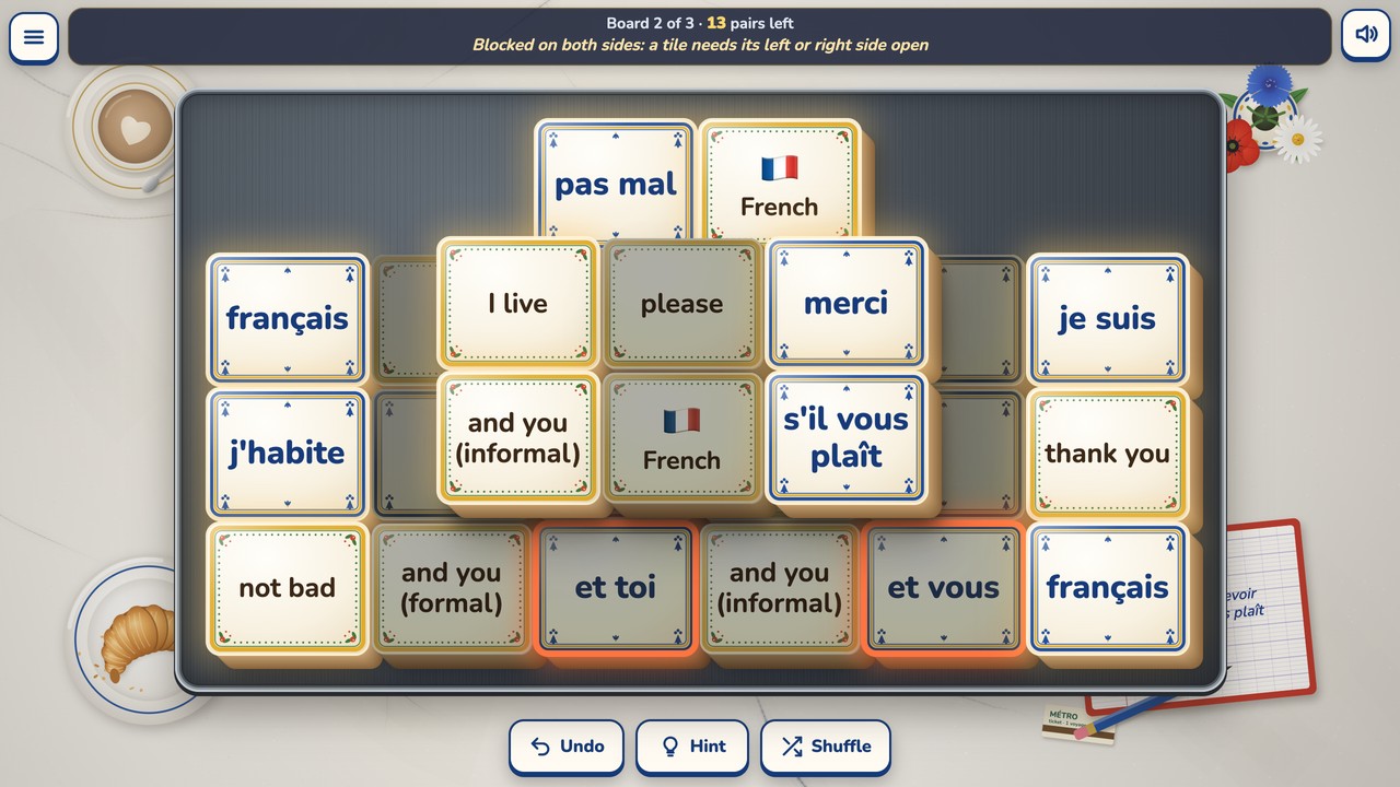 Board 2 with 13 pairs left: the blocked tile and you (informal) was tapped, the two tiles on either side of it, et toi and et vous, glow orange, and the status bar says Blocked on both sides: a tile needs its left or right side open.
